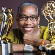 Val Thomas-Matson, producer and star of “Look, Listen and Learn,” smiling while holding Emmy and Telly Awards.