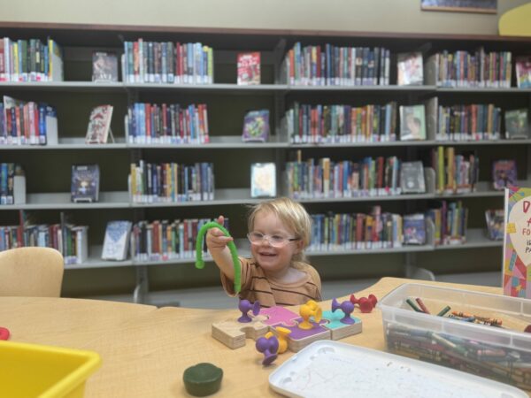 Young child playing in the children’s section of the Camano Island Library