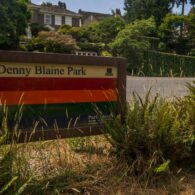 Denny Blaine Park entrance sign with greenery in the background