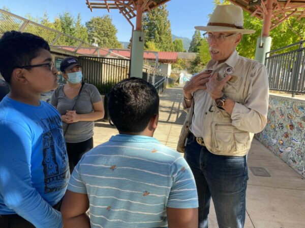 Children chat with a docent at the Issaquah Salmon Hatchery during a tour.