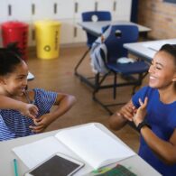 An ASL interpreter communicates with a student in a Seattle Public Schools classroom. Advocates say consistent, qualified interpreting is essential for DHH students to thrive.