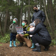Family with a naturalist guide in the park