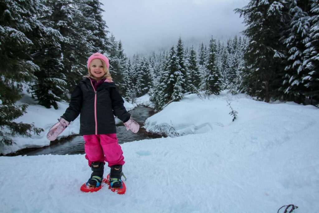Walking past a babbling brook on a snowshoe adventure