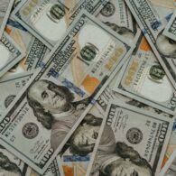 Hundred dollar bills lying on top of eachother.