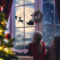 Illustration of kids looking out the window at Santa