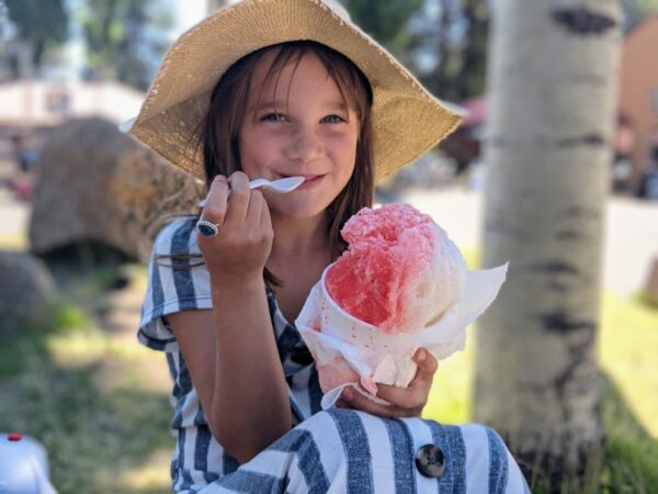 Child enjoying a colorful snow cone in Sunriver Oregon