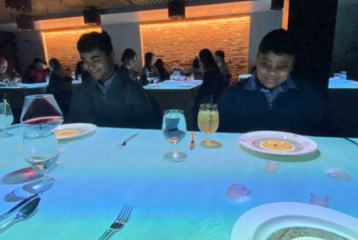 Children watching animated Le Petit Chef projections on their plates during an immersive dining experience in Seattle